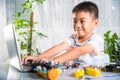 Asian kid boy learns coding and programming with laptop for Arduino robot car