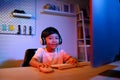 Asian Kid Boy Looking Camera and Smile tries to Gaming Stream on Computer Desktop for Fun and Entertainment at Home, Exploring the