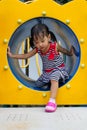 Asian Kid Crawling on Playground Tube