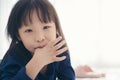 Asian kid cute girl sucking the finger her thumb Royalty Free Stock Photo