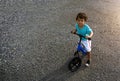 Asian kid first day play balance bike. Royalty Free Stock Photo