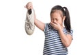 Asian kid girl age 7 year hold stinky shoe on white background Royalty Free Stock Photo