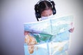 Asian kid girl holding maps world wearing a mask on white background