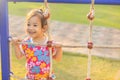 Asian kid girl playing the rope in the playgraound