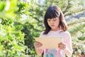 Asian kid girl using tablet for internet communication. Royalty Free Stock Photo