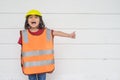 Asian Kid girl wearing reflective shirts and a hat yellow. To learning and enhance development, little architect Royalty Free Stock Photo