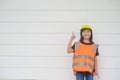 Asian Kid girl wearing reflective shirts and a hat yellow. To learning and enhance development, little architect Royalty Free Stock Photo