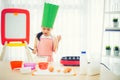 Asian kid having fun with cooking and preparing the dough, bake cookies in the kitchen