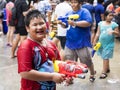 Asian Kid Holding Water Gun at Songkran Festival in Bangkok, Thailand