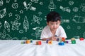 Asian kid learning by playing with his imagination about science