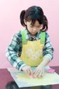 Asian kid making cookies