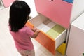 Asian kid open colorful drawer Royalty Free Stock Photo