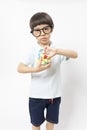 Asian kid play magic rubik cube on white background. Royalty Free Stock Photo