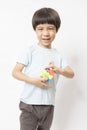 Asian kid play magic rubik cube on white background. Royalty Free Stock Photo