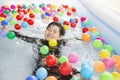 Asian kid is playing in a kid water pool Royalty Free Stock Photo