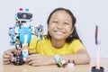 Asian kid presenting her finished robot project Royalty Free Stock Photo