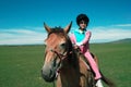 Asian kid riding horse Royalty Free Stock Photo