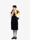 Asian kid schoolgirl in british international uniform carrying backpack full length on white background Royalty Free Stock Photo