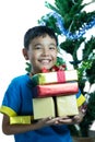 Asian kid smile holding stack of presents boxes Royalty Free Stock Photo