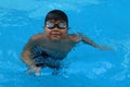 Asian kid standing in swimming pool - happy face smiling Royalty Free Stock Photo