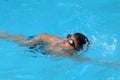 Asian kid swims in swimming pool - front crawl style take deep breath Royalty Free Stock Photo