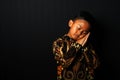 Asian kid wearing Batik with sleeping gesture isolated on black background Royalty Free Stock Photo