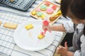 Asian Kids decorating cookies. Royalty Free Stock Photo