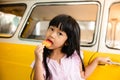 Asian Kids Eating Ice Cream against a Yellow Car in Summer. Looking at Camera Royalty Free Stock Photo