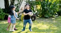 Asian kids playing outdoors with friends. little children play football soccer at nature park. Royalty Free Stock Photo