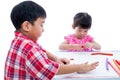 Asian kids playing with play clay on table. Strengthen the imagi