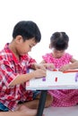 Asian kids playing with play clay on table. Strengthen the imagi