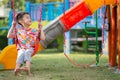 Asian Kids playing swing at playground outdoor with happy smile