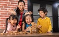 Asian Kids and their teacher are playing wooden block stack game