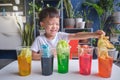 Asian kindergarten boy having fun making Rainbow Cabbage Experiment, Kid learn about how plants thrive by pulling water through