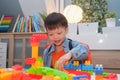 Asian kindergarten boy playing blocks with colorful plastic blocks indoor at home, Educational toys for young children, Stay home