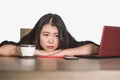 Asian Korean business woman working in stress at office computer desk feeling overwhelmed and frustrated suffering depression thin Royalty Free Stock Photo