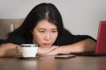 Asian Korean business woman working in stress at office computer desk feeling overwhelmed and frustrated suffering depression thin Royalty Free Stock Photo