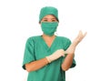 Young beautiful and happy medicine doctor or chief hospital nurse in green scrubs and surgey hat and mask wearing protective latex Royalty Free Stock Photo