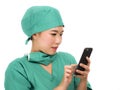 Asian Korean woman as successful physician using hand phone - young beautiful and happy medicine doctor or chief hospital nurse Royalty Free Stock Photo