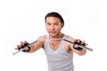 Asian Kung Fu man with chainsticks or nunchaku