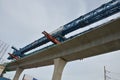 Asian labor people and thai labour worker use machine and heavy machinery working builder railway track electric sky train at