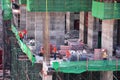 Asian labor people and thai labour workers use machine and heavy machinery working builder new building tower at construction site