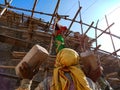 Asian labour holded bricks on hand during house construction work on site in India January 2020