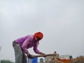 an Asian labour holded spade handle during construction work at sky background in india Dec 2019