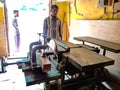 Asian labour stand in front of wood chopping machine at workshop in india January 2020