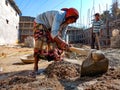 an asian labour woman holded spade handle on construction site