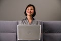 Asian lady in business attire, using a computer