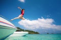Asian lady jump and fly to sky between travel the Thailand sea