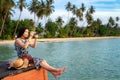 Asian lady relax and take photo on the wooded bridge Royalty Free Stock Photo