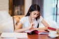 Asian lady student read a text book for prepare to examination o Royalty Free Stock Photo